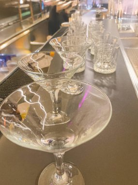 Photograph of neatly arranged martini glasses on a bar counter, showcasing professional setup and ambiance p clipart