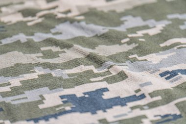 This high-quality image showcases a seamless camouflage pattern inspired by military designs. Featuring a mix of earth tones, dark greens, and muted grays, this realistic Military uniform texture clipart