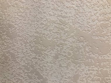 Dökümlü bir duvar resmi, buruşmuş kağıda benzeyen ya da soyulmuş boya rengi pürüzlü desenle çelişen ışık rengi ek özellik ya da bağlam yok