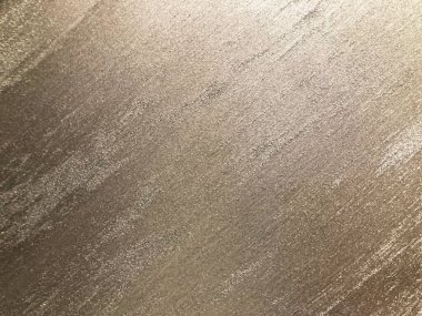 Metal, kumaş ya da boyalı yüzey gölgelerinden yapılmış gibi görünen üç boyutlu altın sarısı yüzeye yakın plan veya metin yok.