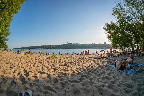 Birlikte var olan insan yapımı yapılar ve doğayla dolu canlı bir sahil sahnesi, çeşitli oturma alanları, sahil sığınakları, peyzaj ve liman manzaraları gösteriyor Doğal çevreciler Kyiv, Ukrayna 06-17-2024
