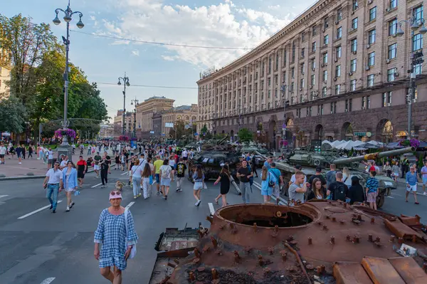 Görüntü, muhtemelen Rus-Ukrayna çatışmasıyla ilgili askeri araçların bulunduğu bir açık hava sahnesini gösteriyor. Tanklar eski ve gelişigüzel park edilmiş. Ayrıca büyük bir St. Kyiv, Ukrayna 08-24-2024