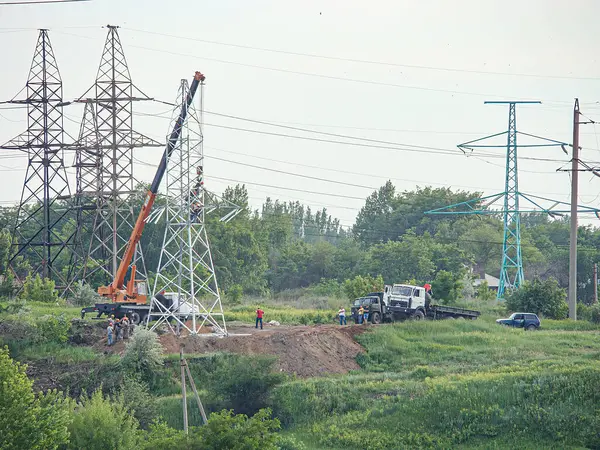 Elektrik santrali odaklı bir inşaat alanı görüntüsü iki büyük trafolar, yüksek voltajlı aktarım hatları, yüksek metal kuleler, vinç, kamyon, Kostiantynivka, Ukrayna, 06-15-2013