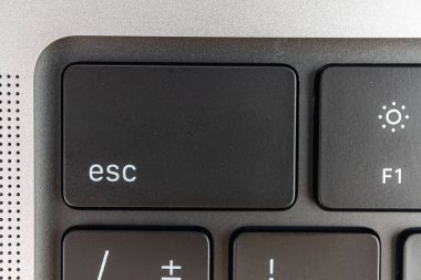 Bir klavye köşesinin yakın plan görüntüsü, Esc anahtarı kısmen görünür anahtarlar ve güç düğmesi pazarlama bağlamında navigasyon veya kısayollar önerir Kompakt düzeni bir dizüstü için önerir