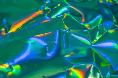 Yüksek çözünürlüklü bir resimde gökkuşağı renklerine sahip parçalanmış, yanardöner bir madde gösterilir. Parça kırılganlığı, esnekliği veya karmaşıklığı simgeler.