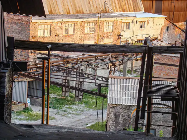 Görüntü, bir binanın iç kısımlarını, açıkta kalan kirişleri, enkazı ve kısmi çatı çökmesini gösteriyor.