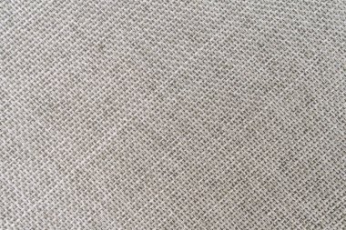 Giysi, iç tasarım, moda, ev dekorasyonu ve aksesuarlar gibi çeşitli uygulamalar için uygun sessiz tonlara sahip yumuşak, tırtıklı bir kumaşın yakın plan görüntüsü