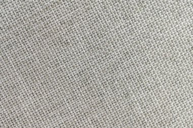 Yumuşak, sessiz renkli kumaş görüntüsü köşegen ve yatay çizgilerin karışımı nötr tonu ve dokunsal doğasını vurgulayarak ev dekoru veya moda için uygundur.