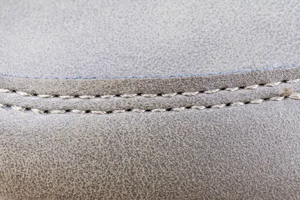 Mobilya detaylarının yakın plan görüntüsü, kalite, dayanıklılık ve ev mobilyaları için uygun stil için dikişli kenler içeriyor.