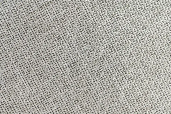 Yumuşak, sessiz renkli kumaş görüntüsü köşegen ve yatay çizgilerin karışımı nötr tonu ve dokunsal doğasını vurgulayarak ev dekoru veya moda için uygundur.