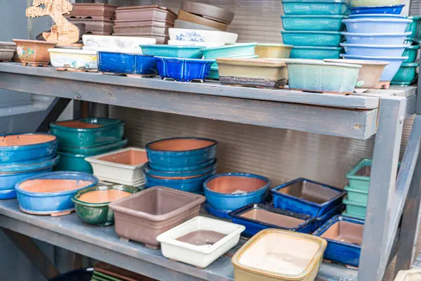 Organize çanak çömlek tabakları, kırsal bir stüdyoda ya da pazar ortamında tabaklar, el yapımı, toprak renkte zanaatkar eşyalar.