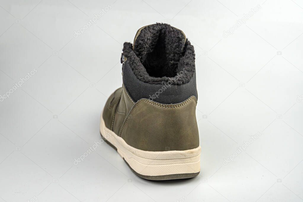The image features a versatile sneaker with outdoor and athletic elements, having a low top profile, lace-up closure, padded ankle collar, textured upper for durability or water resistance, logo on t