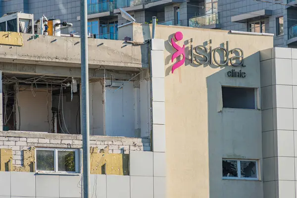 Pembe logolu modern bir minimalist bina kenar mahalle bölgesinde eski ve yıpranmış binalara karşı duruyor. Görüntü, kentsel deve Kyiv, Ukrayna 06-11-2024 'ü simgeleyen durgunluk anını yakalıyor.