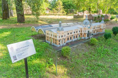 Minyatür bir Rönesans tarzı tarihi yapı modeli, park benzeri bir ortama yerleştirilir. Yapı, Ukrayna, Kyiv, Ukrayna 06-11-2024 adlı bir bilgilendirme ile ayrıntılı detaylandırma ve sütunlar içerir.