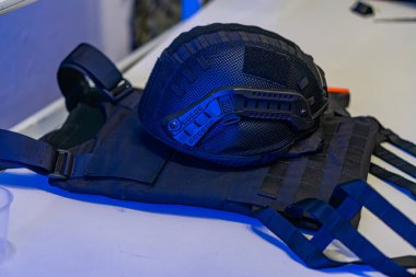 Siyah, kurşun geçirmez yelek, çelik yelek, kolluk kuvvetleri, askeri, koruyucu teçhizat, kemersiz kayışlar, kapalı masa üstü veya tezgah, yumuşak gölgeler, ortam ışığı kaynağı tarafsız ton, samimi fotoğraf.