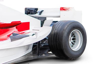 Formula 1 arabasının yakın çekimi, ağırlıklı olarak beyaz, kırmızı aksanlı, karbon fiber açılı arka kanat, siyah jantlarda kaygan yarış lastikleri, yapay ışıklandırma, yan profil görüntüsü gerçekçi.