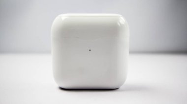 Beyaz kablosuz kulaklık veya kulaklık ve şarj çantası beyaz arkaplanda izole.