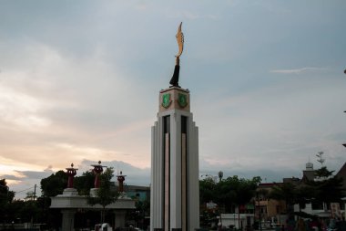 Sukabumi, Indonesia - January 14th 2024 : Kujang Monument, Sukabumi City Square or tugu Kujang Alun Alun Kota Sukabumi with Sunset Sky cloud on Twilight clipart