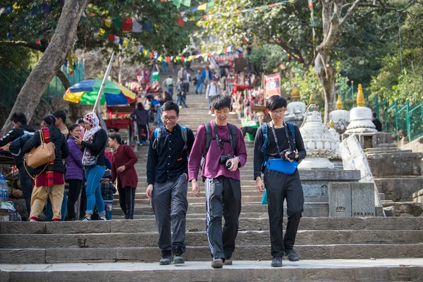 stock image Kathmandu, Nepal- April 20,2022 : Tourists visit the ancient stupas of Swayambhunath temple high above Kathmandu.