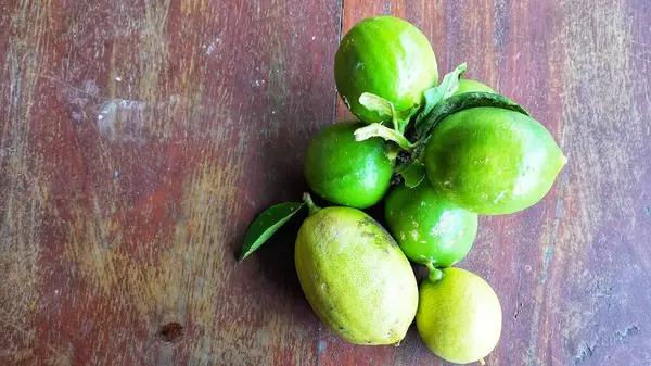 Ripe lemon fruit on branch with green leaves. Lemon fruit with green leaf. Natural Lemon fruit levitate. Fresh yellow ripe lemons.
