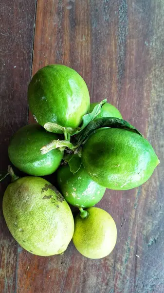 Ripe lemon fruit on branch with green leaves. Lemon fruit with green leaf. Natural Lemon fruit levitate. Fresh yellow ripe lemons.