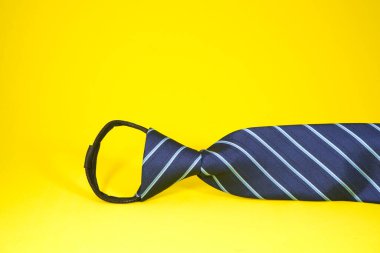 Sarı arka plan yakın görüntüsüne önceden düğümlenmiş çizgili fermuar kravat 