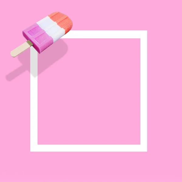 Ice cream popsicle with white frame on vivid pink background and copy space. Minimal summer composition. Flat lay