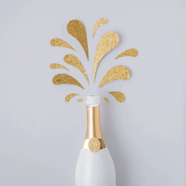 Contemporary Layout Made Champagne Bottle Golden Glittering Splashes White Background — Stock Photo, Image