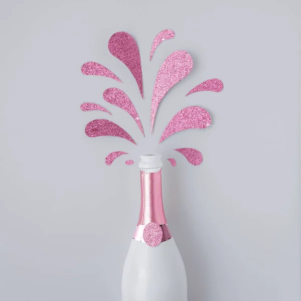 Contemporary Layout Made Champagne Bottle Pink Glittering Splashes White Background — Stock Photo, Image