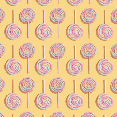 Pastel sarı arka planda lolipoplardan yapılmış renkli desen. Düz lai. Tatlılar konsepti.