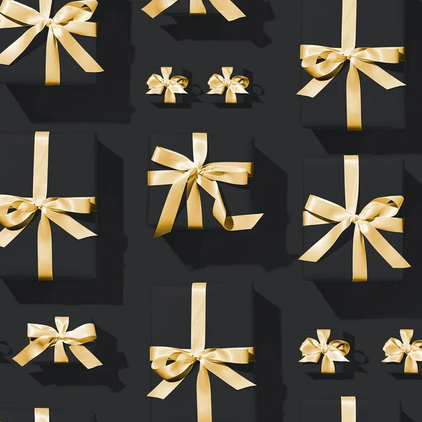 Minimální Složení Tmavě Černého Pozadí Zlaté Luky Vánoční Dárkové Krabice — Stock fotografie
