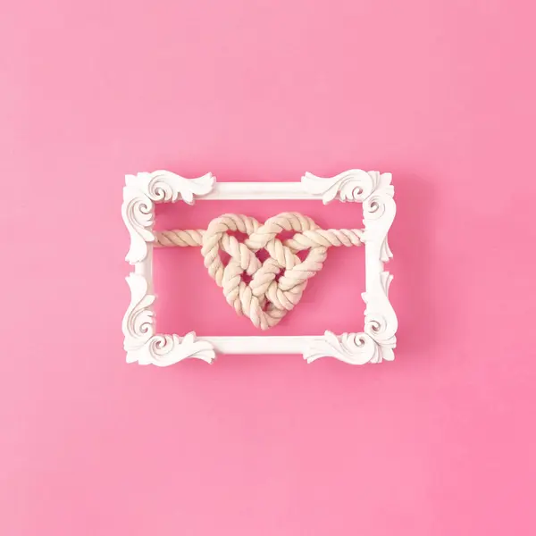Corda Forma Coração Uma Moldura Clássica Branca Fundo Rosa — Fotografia de Stock