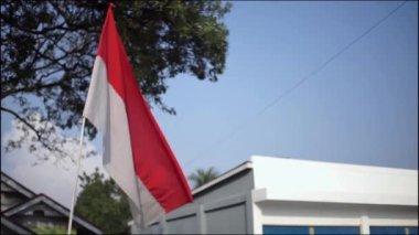 Endonezya 'nın bağımsızlık gününe hoş geldin demek için yol kenarında dalgalanan kırmızı ve beyaz bayrak..