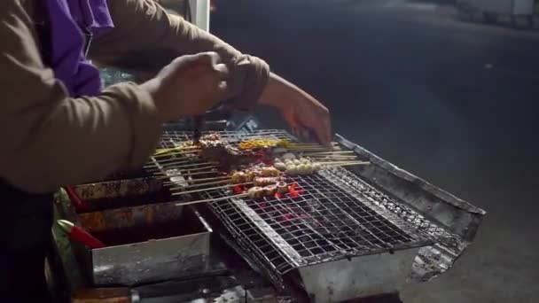 Male Street Food Vendor Grilling Grilled Meatballs Tofu Intestinal Satay — Stock Video