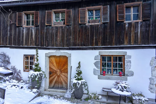 Idillic traditional rustic building exterior in Hallstatt Austria with wooden details .