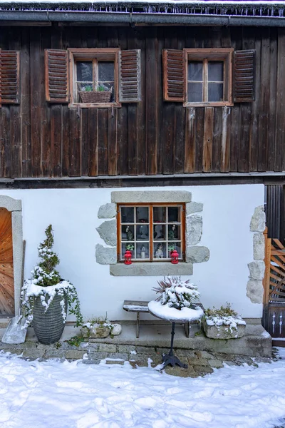 Idillic traditional rustic building exterior in Hallstatt Austria with wooden details .