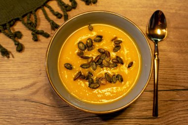 pumpkin soap with seads in a plate on wooden table