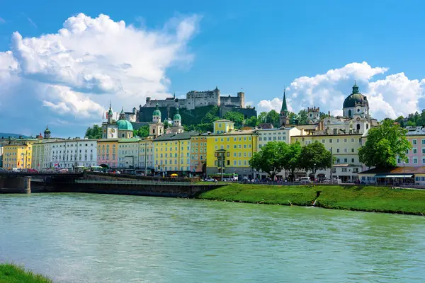 stock image Salzach riverbank in Austria Salzburg with towers and the castle skyline of the city .