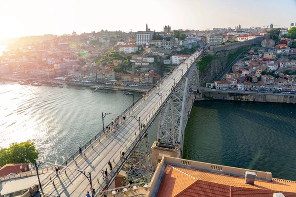 stock image dom luiz brige in Porto on the riverside of Duero river cityscape at sunset from above view from Mosteiro da Serra do Pilar .