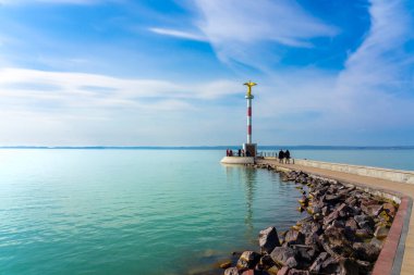 pier in Siofok Hungary with a gold angel statue and walking path . clipart