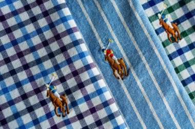 3 colorful close up stitched ralph lauren logo on shirts . clipart