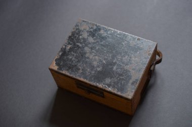 Kapalı ahşap kutu. Deri saplı, antika bir analog voltmetre..