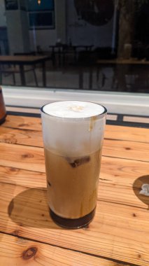 Cappuccino on a wooden table backgroundCappuccino on a wooden table background