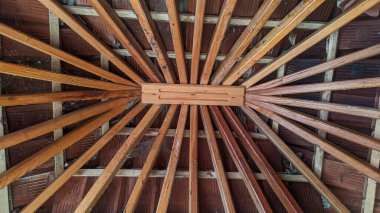 brown wooden berugak with a symmetrical texture