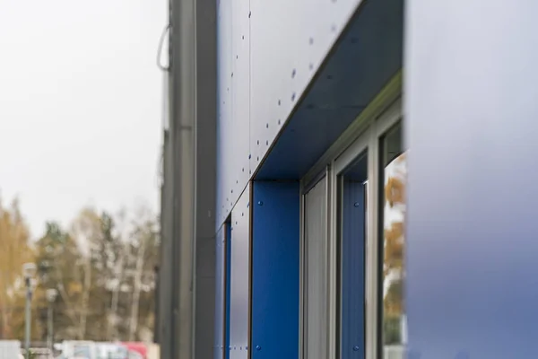Colorful facade of the object, building. Material of vertical blue panels.