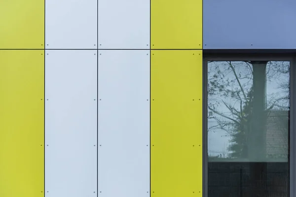 Colorful facade of the object, building. Material of vertical panels.