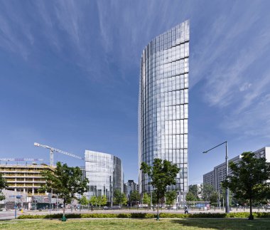 Gökdelen, gökdelen, ofis binası. Güneşli bulutsuz hava. Harmony, düz çizgiler. Şehir trafiği, kavşak