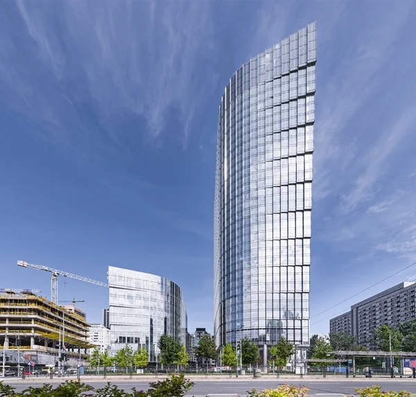 Gökdelen, gökdelen, ofis binası. Güneşli bulutsuz hava. Harmony, düz çizgiler. Şehir trafiği, kavşak