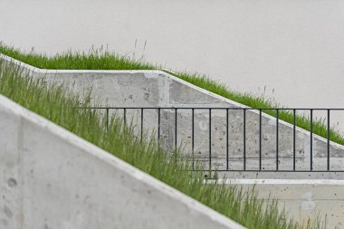 Detail on walkways made of concrete in a modern multifamily building in a European city. clipart