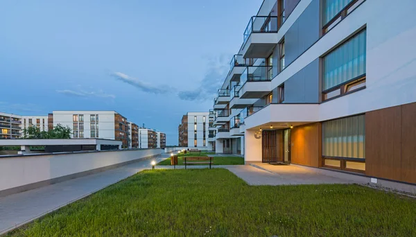 stock image A modern multifamily building in a European city at night by artificial light. Blue hour